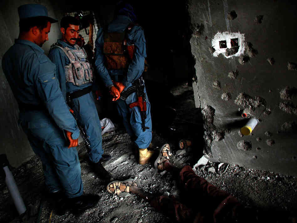Sept. 13: Afghan Security personnel stand above the body of one attacker, on the 10th floor of the building in Kabul from which RPGs and other weapons were fired toward the U.S. embassy.