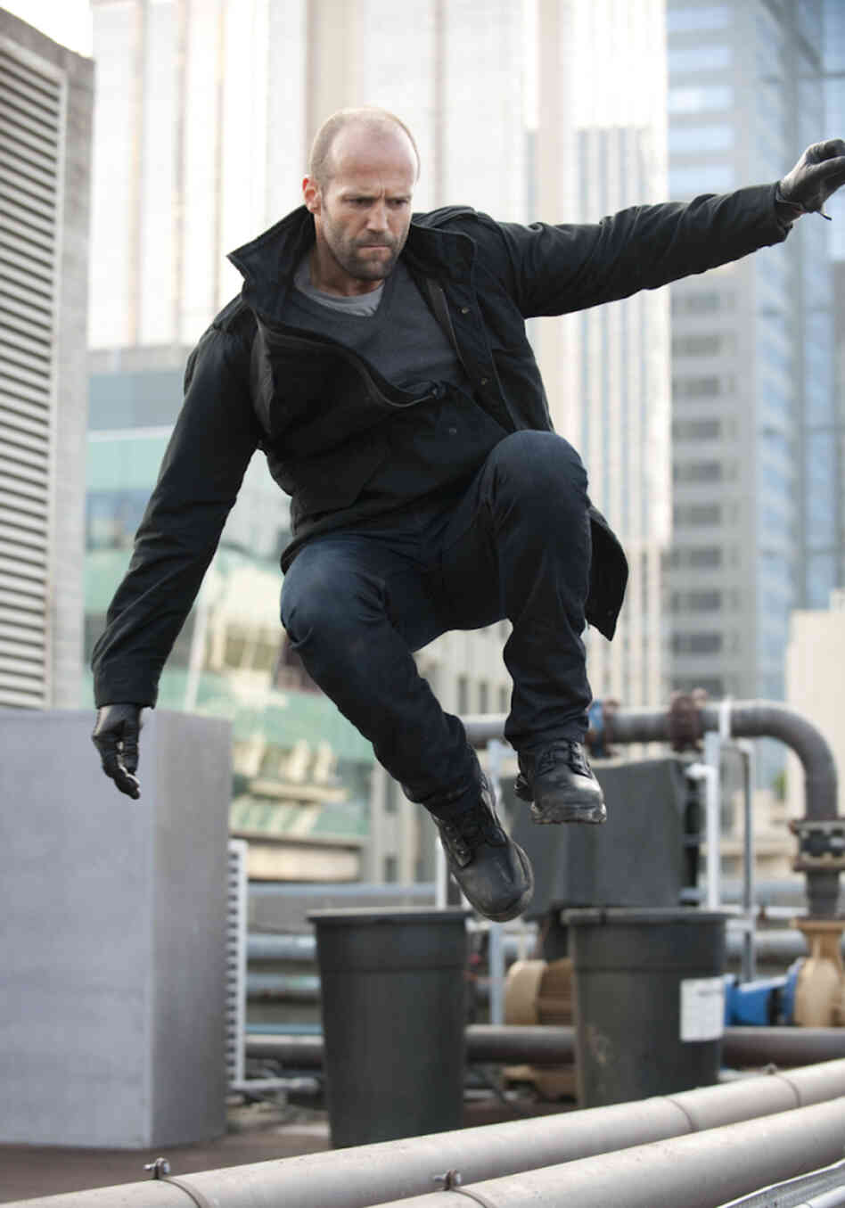 Statham plays his usual charismatic stoic — leaping tall buildings and wooing stunning women as he chases down the bad guys.