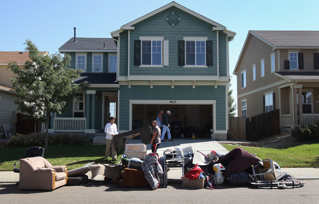 An eviction team removes furniture during a home foreclosure in Longmont, Colorado.