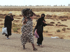 Libyans flee on foot along the main road heading west, away from Sirte, on Tuesday. Sirte, cut off from the rest of the country, is the last major town controlled by forces loyal to toppled dictator Moammar Gadhafi. Libyans flee on foot along the main road heading west, away from Sirte, on Tuesday. Sirte, cut off from the rest of the country, is the last major town controlled by forces loyal to toppled dictator Moammar Gadhafi.