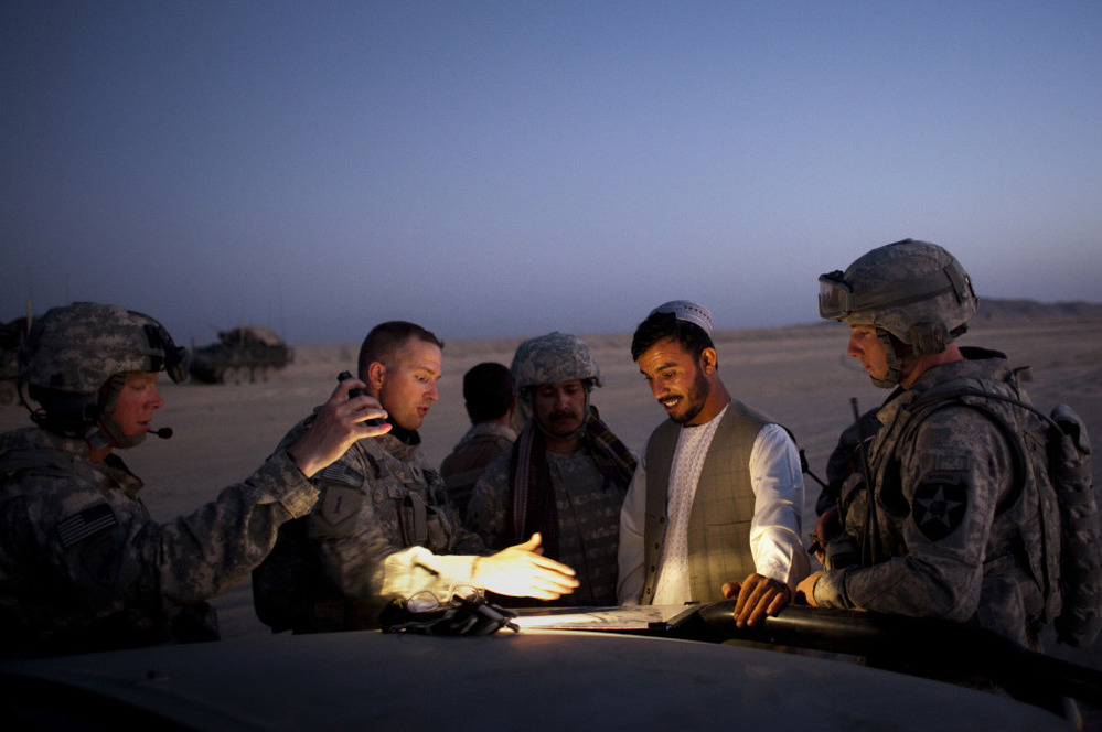 During a patrol in 2009, Gen. Abdul Raziq of Afghanistan's border police (center) talks with U.S. Lt. Col. William Clark near the Afghan border with Pakistan.