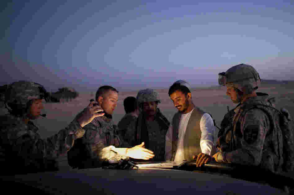 During a patrol in 2009, Gen. Abdul Raziq of Afghanistan's border police (center) talks with U.S. Lt. Col. William Clark near the Afghan border with Pakistan.