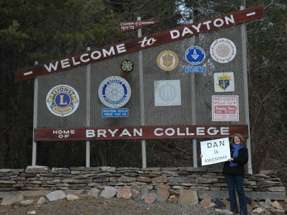 Proverbs 31:23 says that a virtuous woman's husband is "respected at the city  gate," so Evans made a poster that said "Dan is Awesome" and stood in front of  the "Welcome to Dayton" sign for 30 minutes one  afternoon.