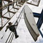 Ben Shaw hangs from an oil derrick outside Williston, ND, in July 2011. Williston's mayor, Ward Koeser, estimates that the town has between 2,000 and 3,000 job openings for oil workers.