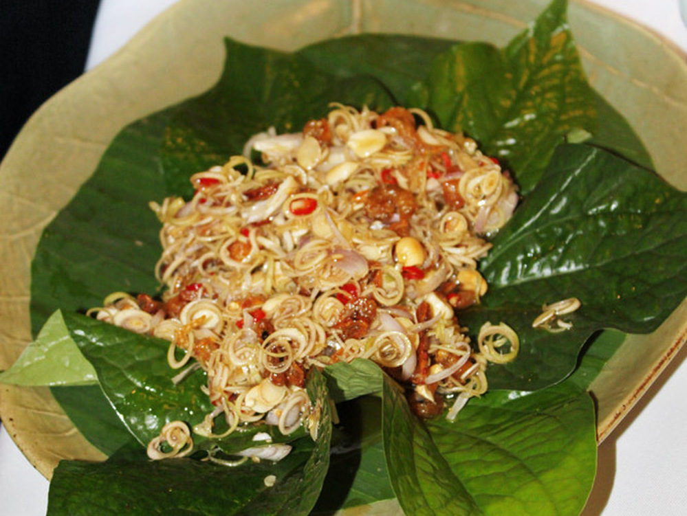 A freshly tossed Thai lemongrass salad is served on betel leaves at Naj, a Bangkok restaurant