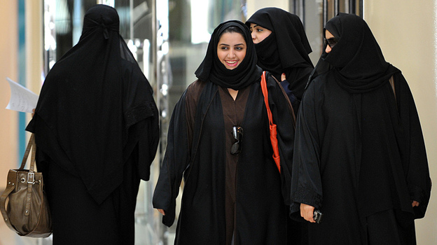 Saudi women walk inside the 'Faysalia' mall in Riyadh , on September 26, 2011, a day after Saudi Arabia's King Abdullah bin Abdulaziz al-Saud granted women the right to vote and run in municipal elections.