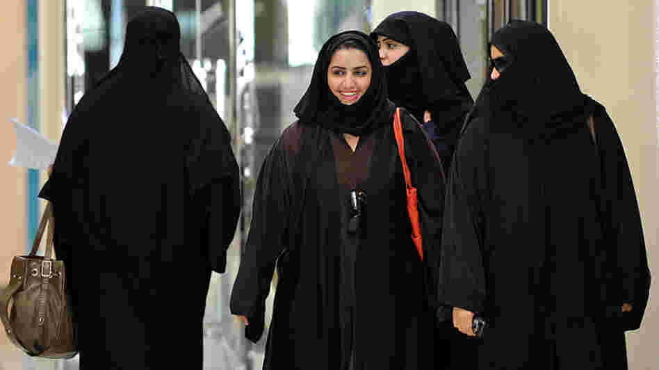Saudi women walk inside the 'Faysalia' mall in Riyadh , on September 26, 2011, a day after Saudi Arabia's King Abdullah bin Abdulaziz al-Saud granted women the right to vote and run in municipal elections.