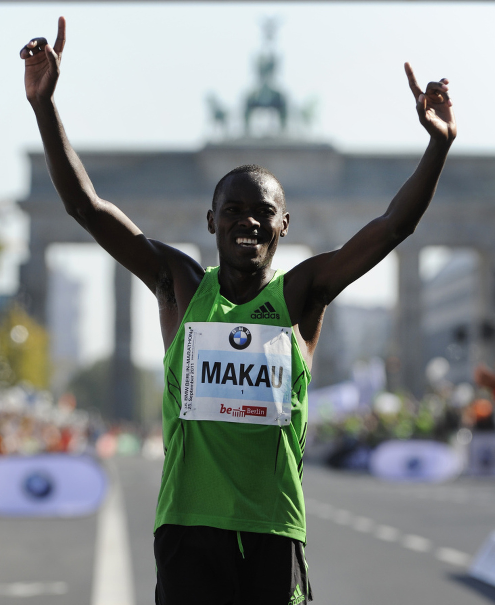 Patrick Makau of Kenya celebrates in front of Berlin's Brandenburg Gate after setting a new world record for the marathon.