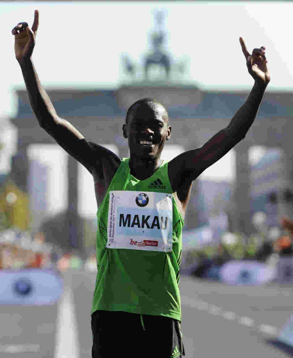 Patrick Makau of Kenya celebrates in front of Berlin's Brandenburg Gate after setting a new world record for the marathon.