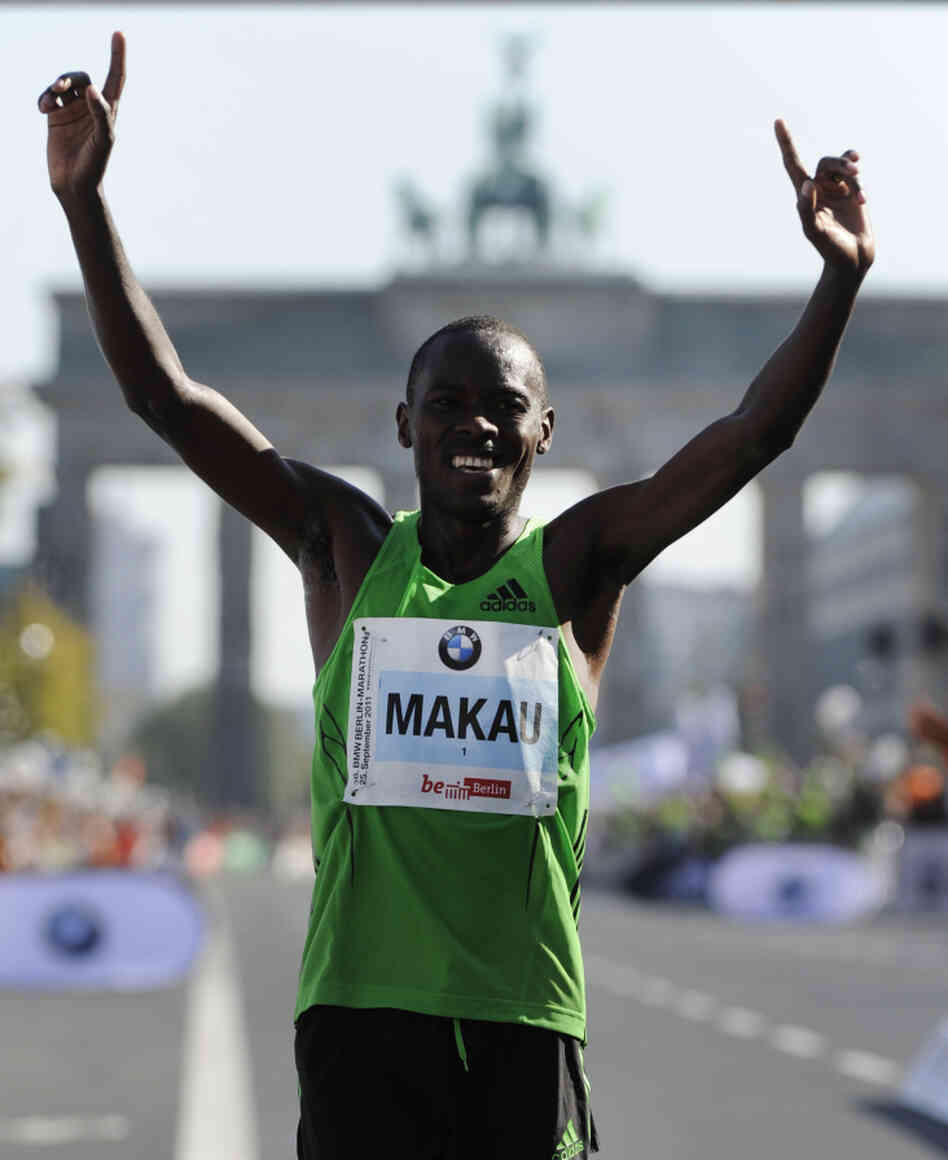 Patrick Makau of Kenya celebrates in front of Berlin's Brandenburg Gate after setting a new world record for the marathon.