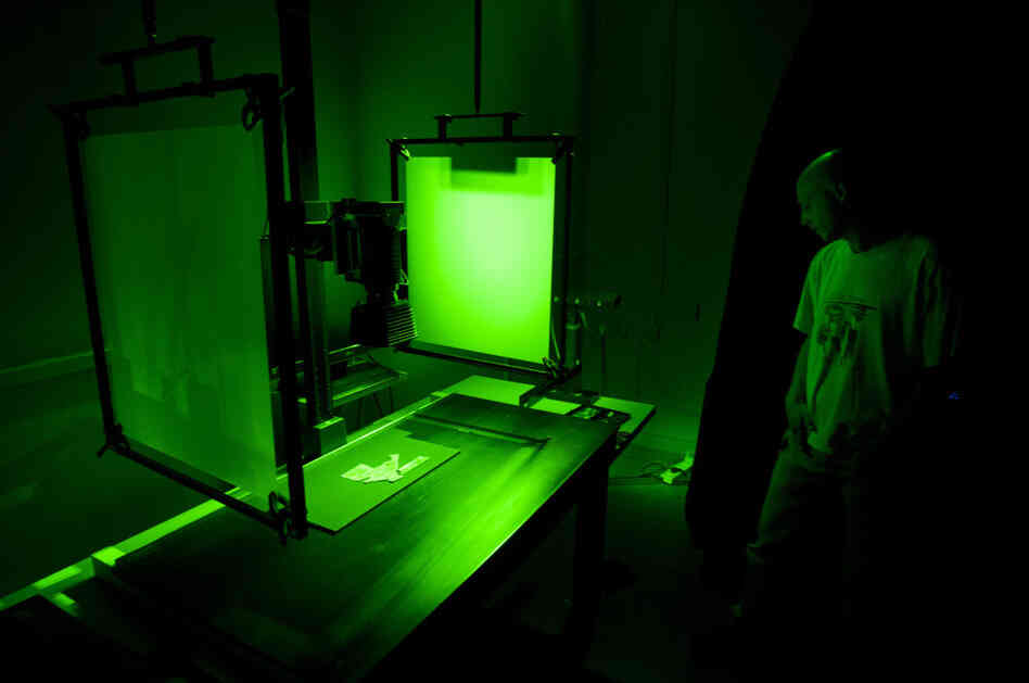 Shai Halevi, a photographer working for the Israel Antiquities Authority, IAA, photographs fragments of the Dead Sea Scrolls.