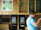 Manuel Martinez, the manager of a popular salad restaurant in Washington, D.C., called Sweetgreen, assists a customer. Martinez says customers use the QR code on the wall to learn about promotions and to get discounts. Manuel Martinez, the manager of a popular salad restaurant in Washington, D.C., called Sweetgreen, assists a customer. Martinez says customers use the QR code on the wall to learn about promotions and to get discounts.