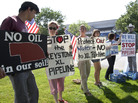 Protestors opposed to the Keystone XL pipeline hold signs outside the office of Rep. Lee Terry, R-Neb., in Omaha, Neb., Tuesday, July 26, 2011. Protestors opposed to the Keystone XL pipeline hold signs outside the office of Rep. Lee Terry, R-Neb., in Omaha, Neb., Tuesday, July 26, 2011.