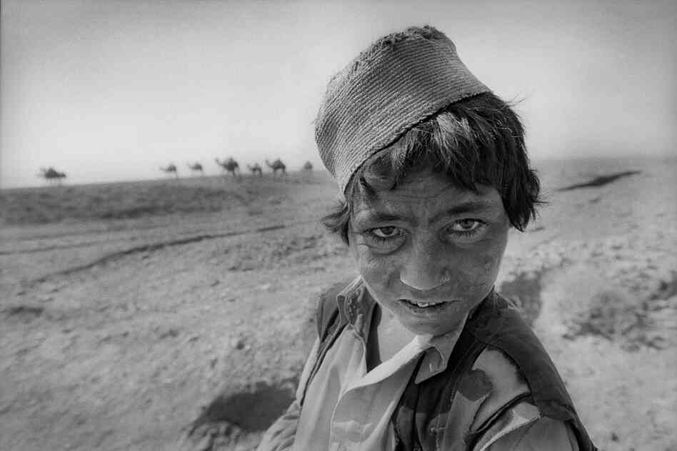 Camel herder Ajnabi Gul is eight years old. The wind and sun on the plains are ferocious, Herat Province, 2003.