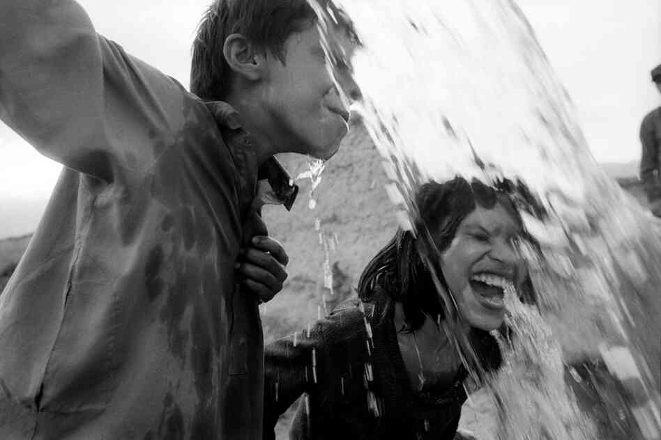 Children cool down after a day's work in the fields, Parwan Province, 2004.