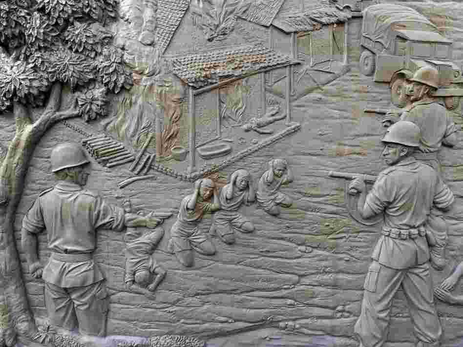 A mural at the Rawagede monument of independence (shown here on Sept. 15) depicts the 1947 massacre by Dutch military troops. The Dutch government long ago admitted to the killings and donated money to the village — but refused to link the funds to the massacre.
