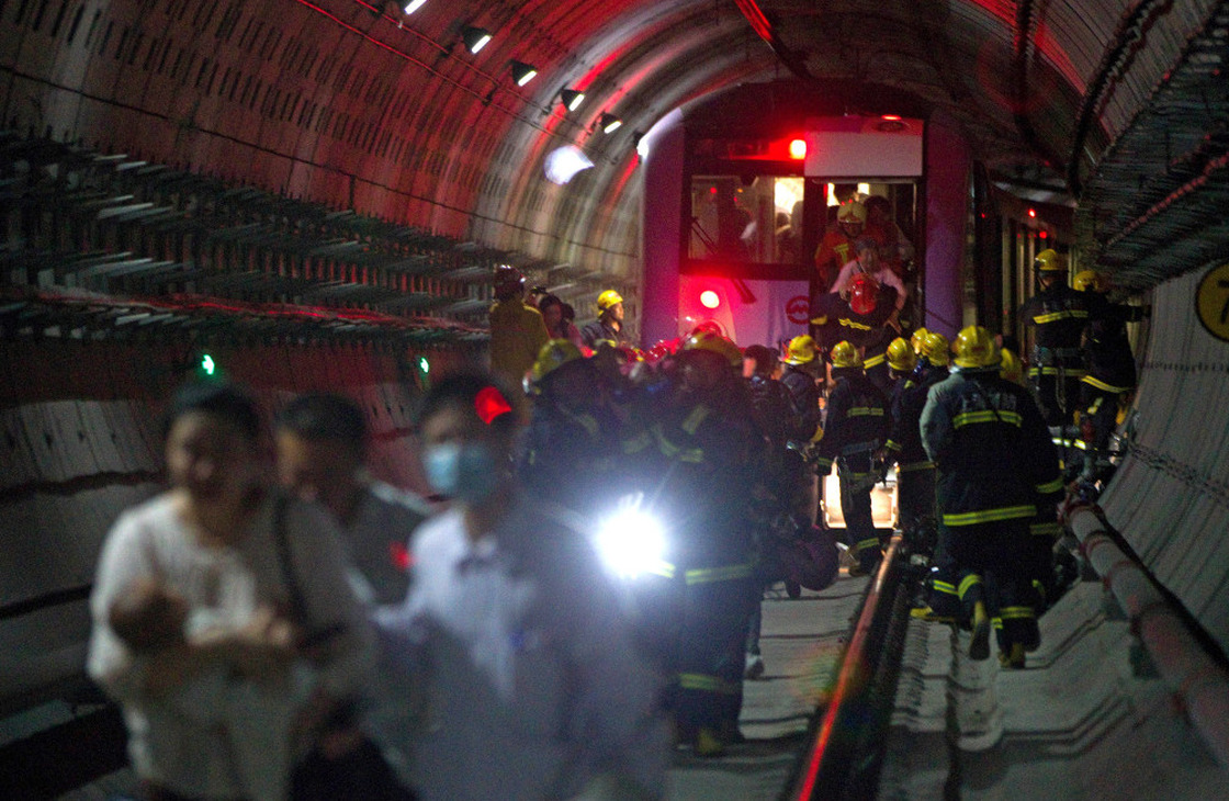 Rescue workers evacuated passengers after a subway train crashed into another train between stations Tuesday in Shanghai.