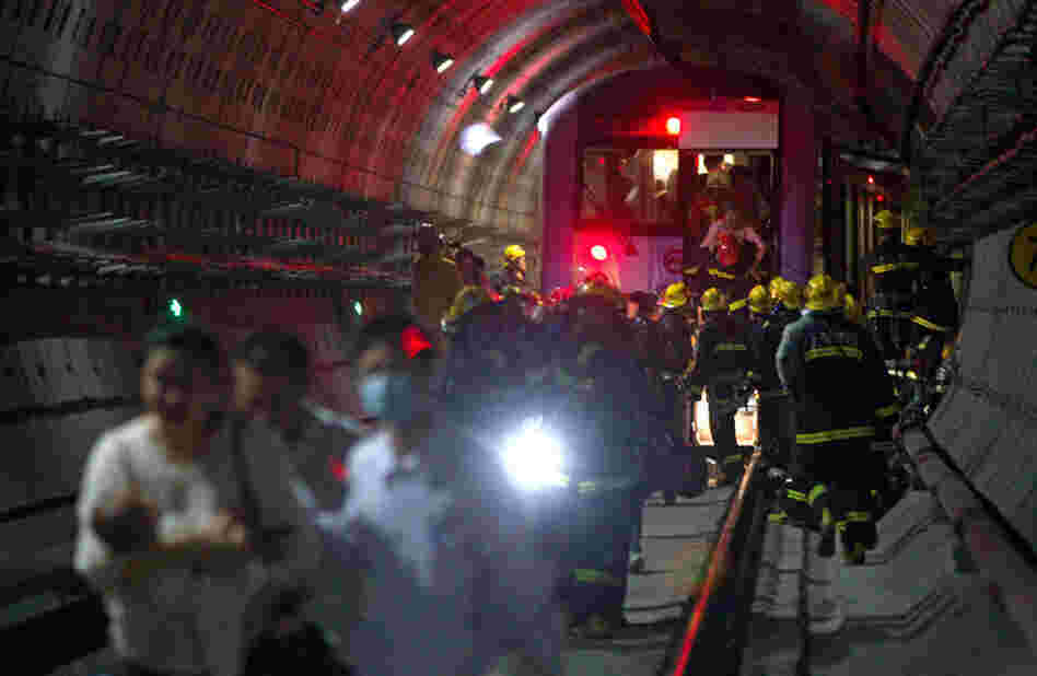 Rescue workers evacuated passengers after a subway train crashed into another train between stations Tuesday in Shanghai.
