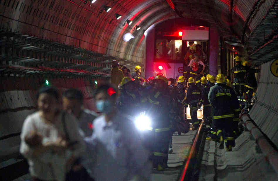 Rescue workers evacuated passengers after a subway train crashed into another train between stations Tuesday in Shanghai.