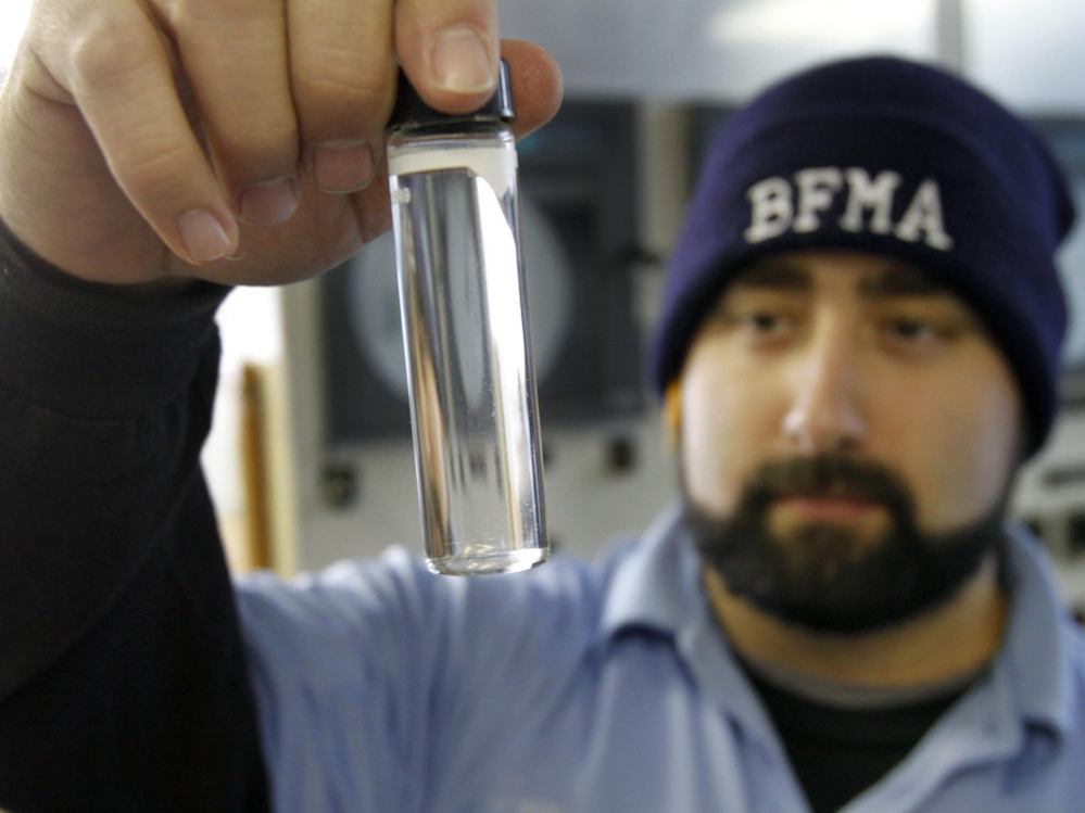 Water plant operator Torrey Jones checks the clarity of a sample of treated water at the Beaver Falls Municipal Authority water treatment plant in Beaver Falls, Pa.