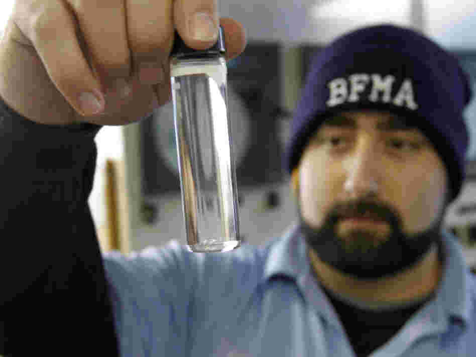 Water plant operator Torrey Jones checks the clarity of a sample of treated water at the Beaver Falls Municipal Authority water treatment plant in Beaver Falls, Pa.