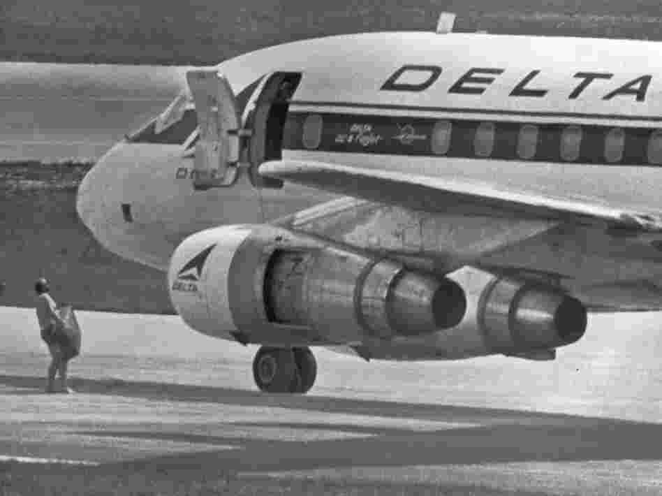 July 1972: an FBI agent, wearing only a pair of swim trunks, per the hijackers' instructions, carries a case containing a $1 million ransom to the opened door of a hijacked Delta DC8 jet in Miami. The jet later took off for Algeria. George Wright, a convicted killer and 1970s militant, was among the hijackers.