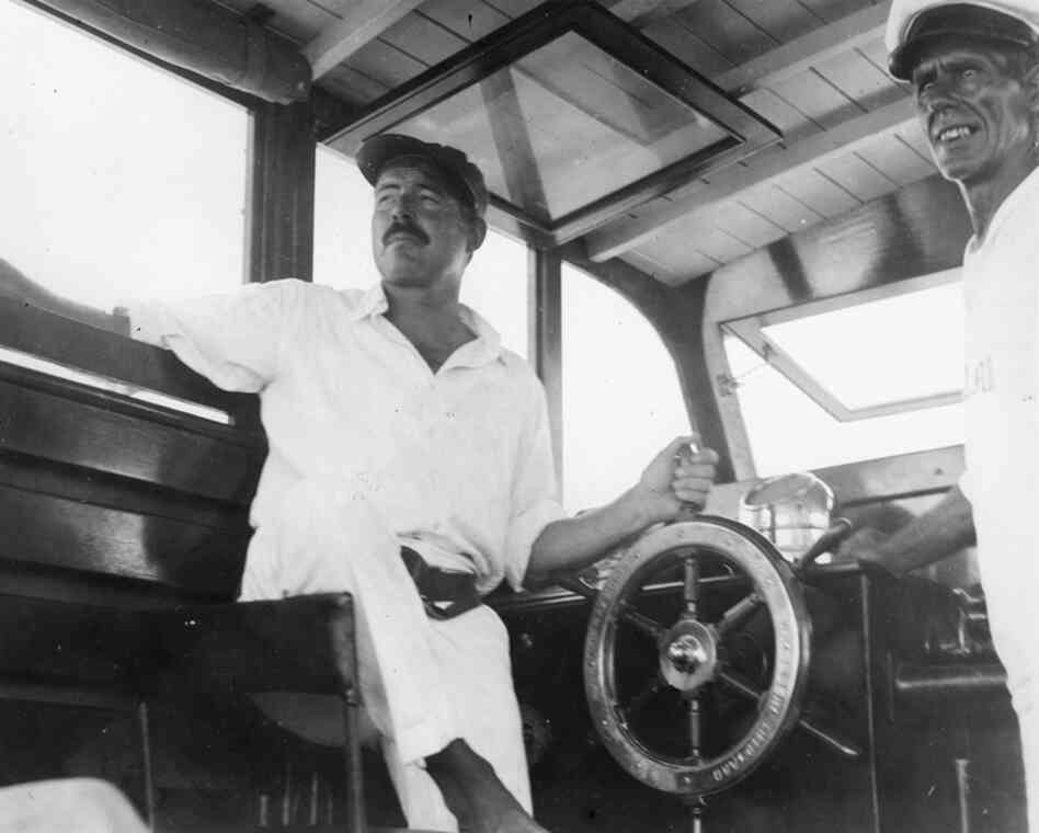 Ernest Hemingway (left) and his guide Carlos Gutierrez navigate Hemingway's boat, Pilar, in 1934.