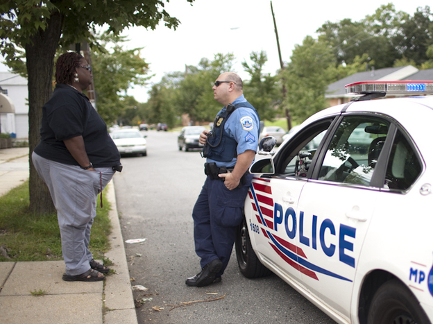 Earline Budd, a transgender advocate, speaks to a D.C. police officer about a spate of attacks in Washington, D.C.