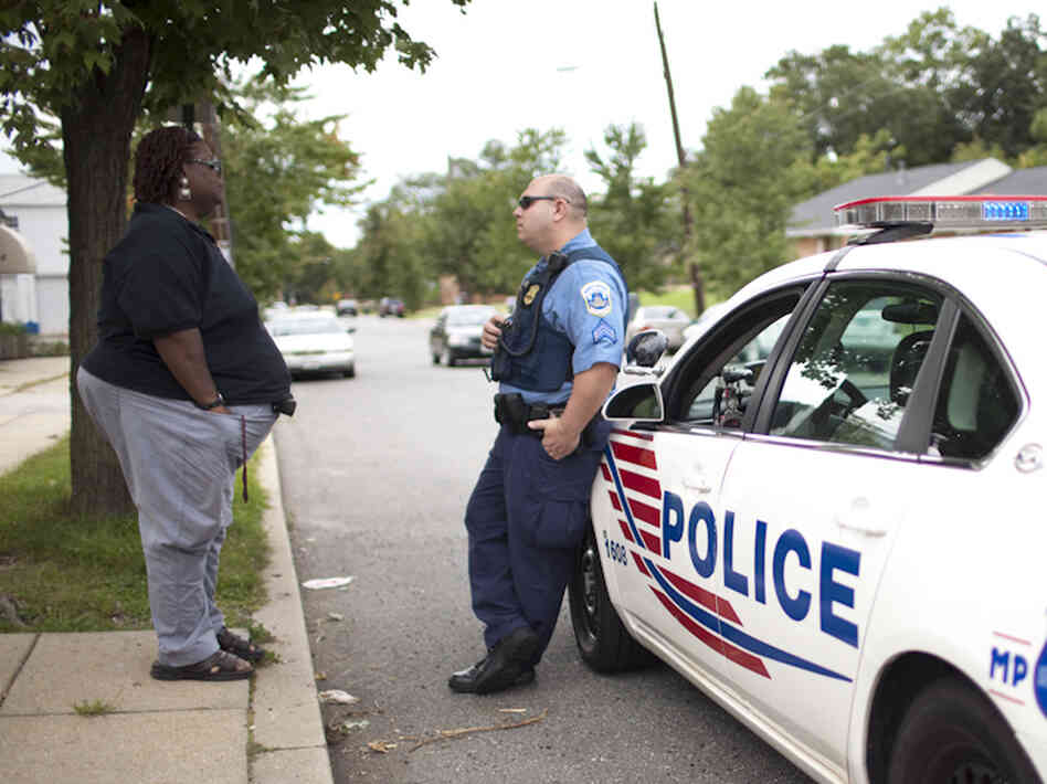 Earline Budd, a transgender advocate, speaks to a D.C. police officer about a spate of attacks in Washington, D.C.