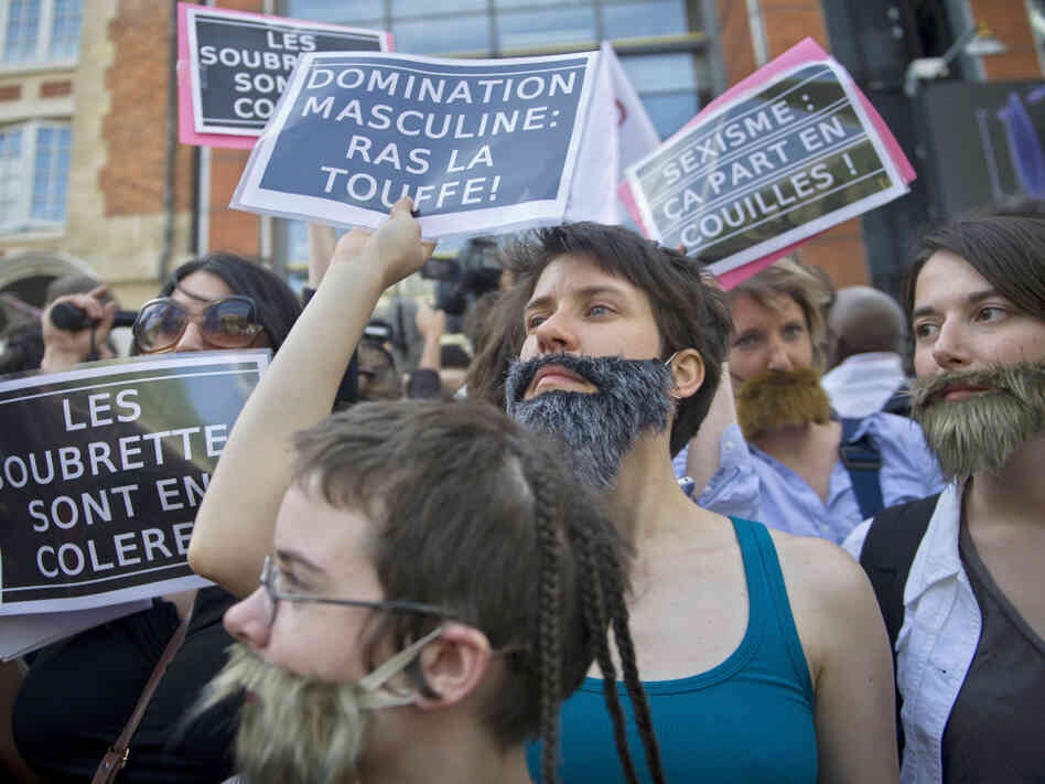 Women, mostly members of feminist groups, wear fake mustaches and beards, and hold anti-sexist placards as they stage a demonstration in Paris in May against the political and media reaction to the sexual assault allegations against former IMF chief Dominique Strauss-Kahn.