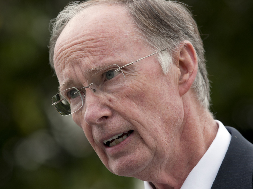 Gov. Robert Bentley talks with reporters outside the Capitol in Montgomery, Ala.,  on Wednesday. Bentley said he will work with the state attorney general to appeal the parts of the decision that struck down sections of the state's illegal immigrant law.