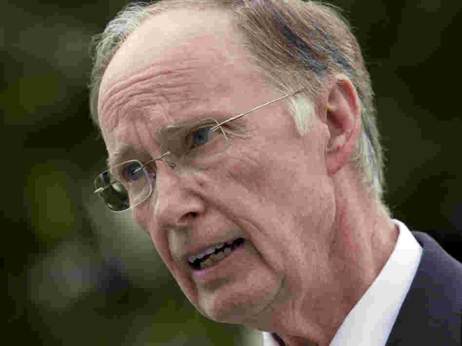 Gov. Robert Bentley talks with reporters outside the Capitol in Montgomery, Ala.,  on Wednesday. Bentley said he will work with the state attorney general to appeal the parts of the decision that struck down sections of the state's illegal immigrant law.