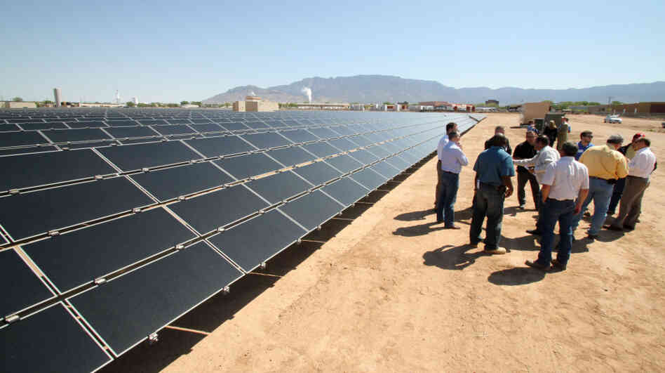 Officials from Arizona-based First Solar and a New Mexico power company gather after the dedication of a new solar array in Albuquerque in April. Officials from Arizona-based First Solar and a New Mexico power company gather after the dedication of a new solar array in Albuquerque in April.