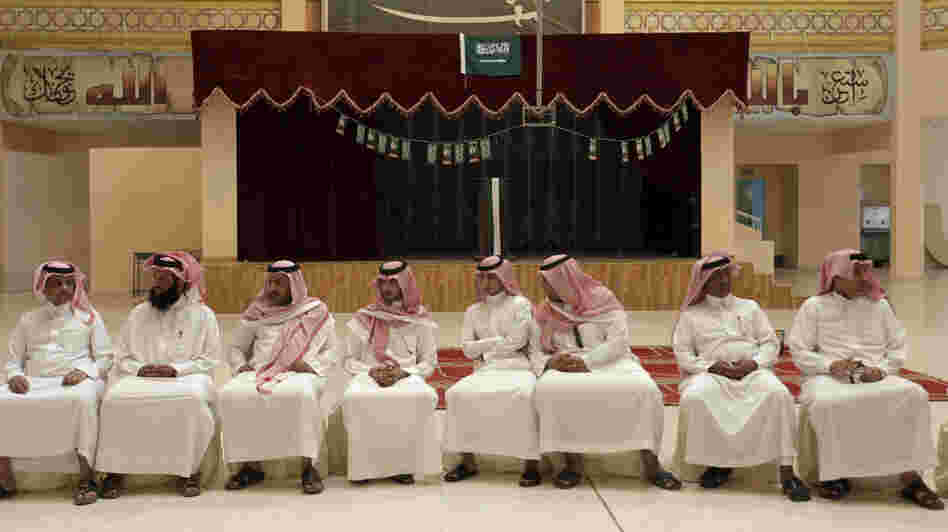 Saudi men wait to cast their votes in municipal elections in Riyadh, Saudi Arabia, on Thursday. Turnout appeared to be low. King Abdullah says that women will be allowed to vote in the next municipal elections, in 2015. Saudi men wait to cast their votes in municipal elections in Riyadh, Saudi Arabia, on Thursday. Turnout appeared to be low. King Abdullah says that women will be allowed to vote in the next municipal elections, in 2015.