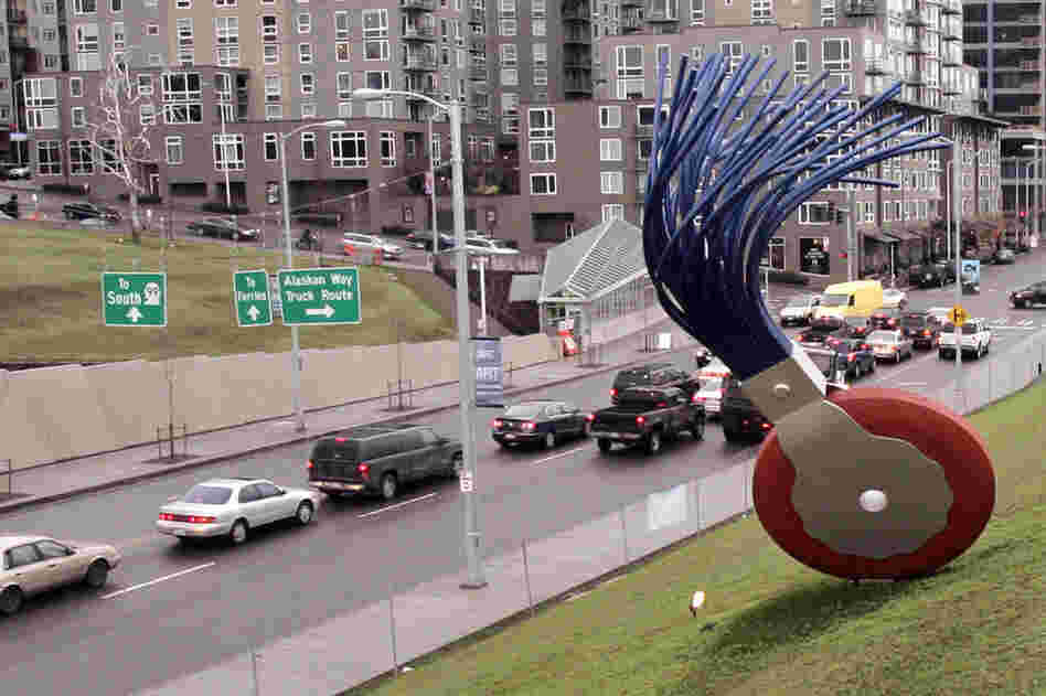 The 19-foot-tall Typewriter Eraser, Scale X, by Oldenburg and van Bruggen, stands in view of traffic passing Seattle's Olympic Sculpture Park. 