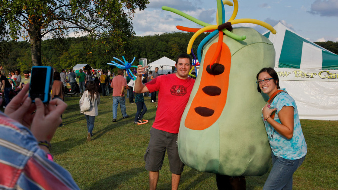 Fans pose for a picture with a pawpaw character at the 13th Annual Pawpaw Festival in Albany, OH.