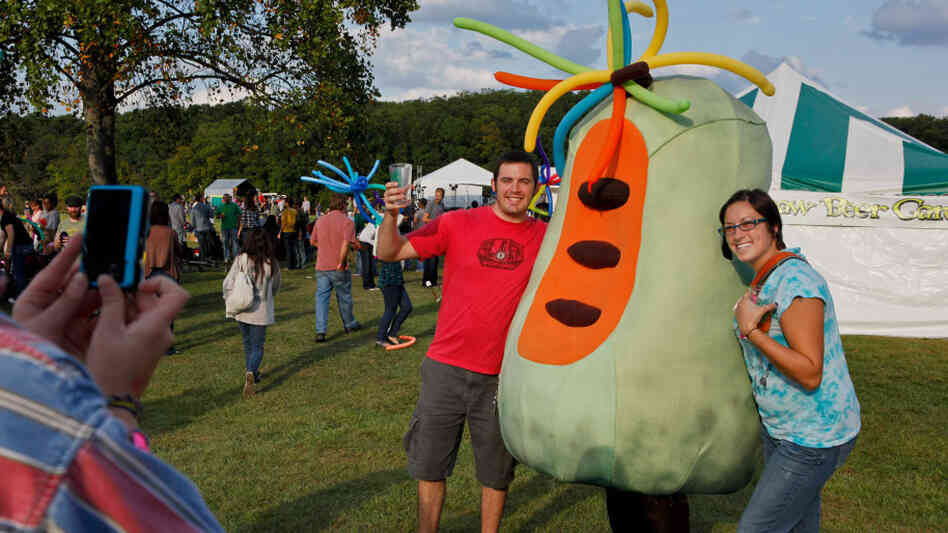 Fans pose for a picture with a pawpaw character at the 13th Annual Pawpaw Festival in Albany, OH.