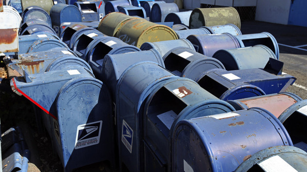 U.S. Postal Service mailboxes are seen awaiting disposal in San Jose, Calif. Because of steeply declining use, the U.S. Postal Service has removed more than 60 percent of the blue boxes.