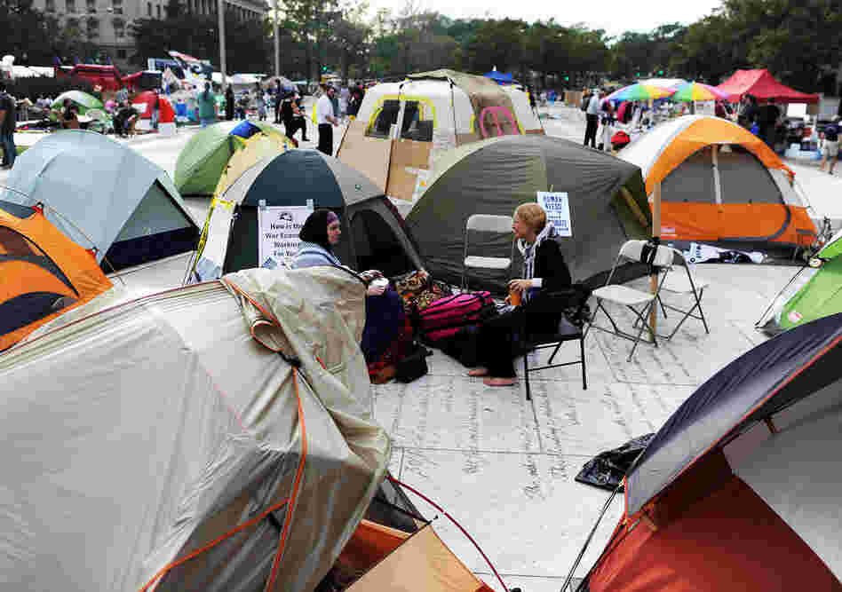 Protesters sit around their tents during "Occupy DC" anti-corporations protest. 