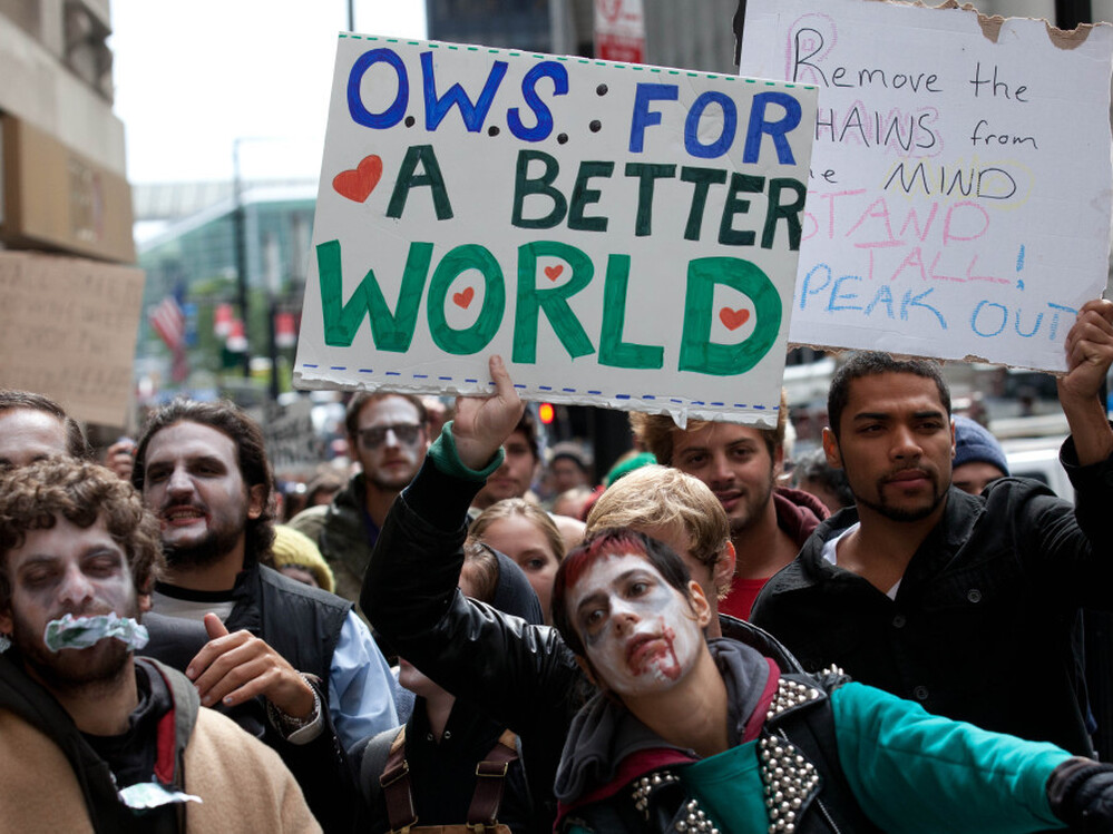 Protesters march through New York's financial district dressed as corporate zombies on Monday. 