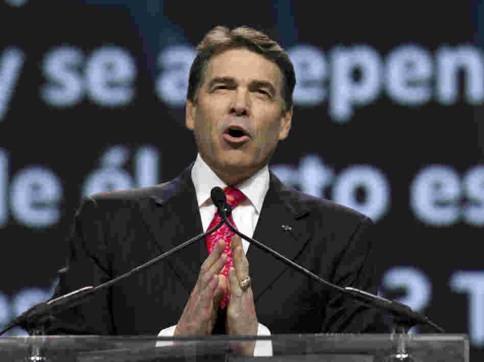 Texas Gov. Rick Perry prays at The Response, his call to prayer for a nation in crisis, on Aug. 6 in Houston. The event was organized, in part, by members of the New Apostolic Reformation.