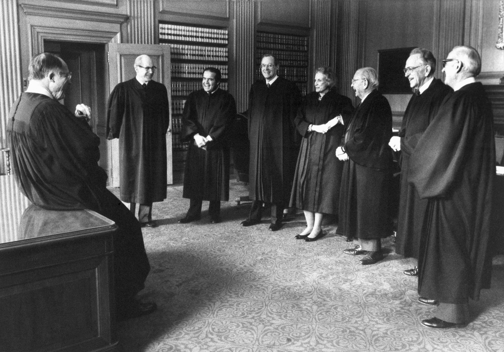 February 1988: Chief Justice William Rehnquist (left) gathers with the court before the investiture of Anthony Kennedy. From left: Rehnquist, Byron White, Antonin Scalia, Kennedy, Sandra Day O'Connor, William Brennan, Harry Blackmun and John Paul Stevens.