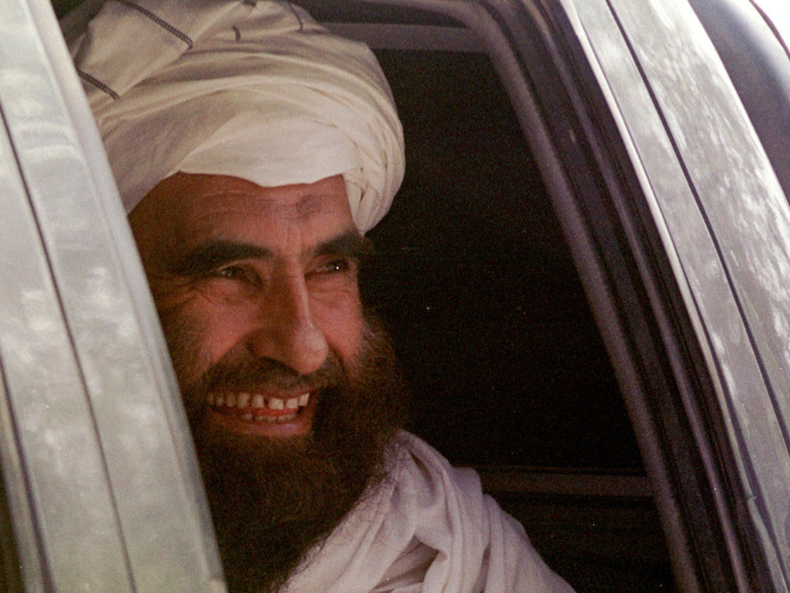 In this archive photo from October 21, 2001, Jalaluddin Haqqani smiles as he leaves after a meeting with Jama"at-i-Islami leaders in Islamabad, Pakistan.