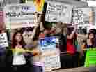 Protesters shout slogans while holding banners Monday at  Occupy Wall Street protests in Los Angeles. 
