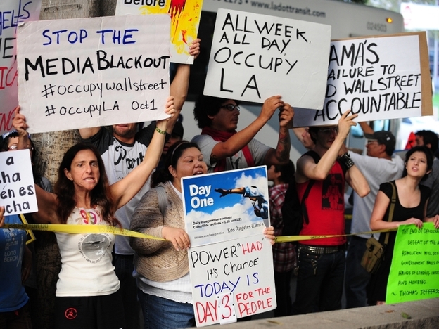 Protesters shout slogans while holding banners Monday at  Occupy Wall Street protests in Los Angeles. 