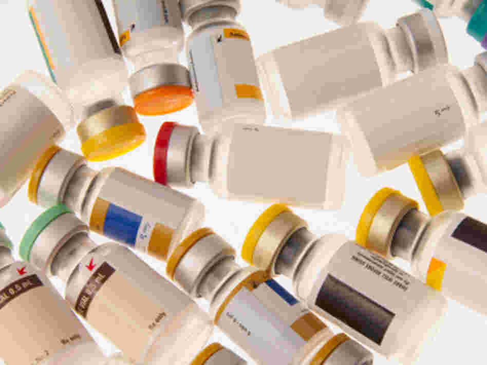 Vials of different vaccines with color-coded caps. Vials of different vaccines with color-coded caps.