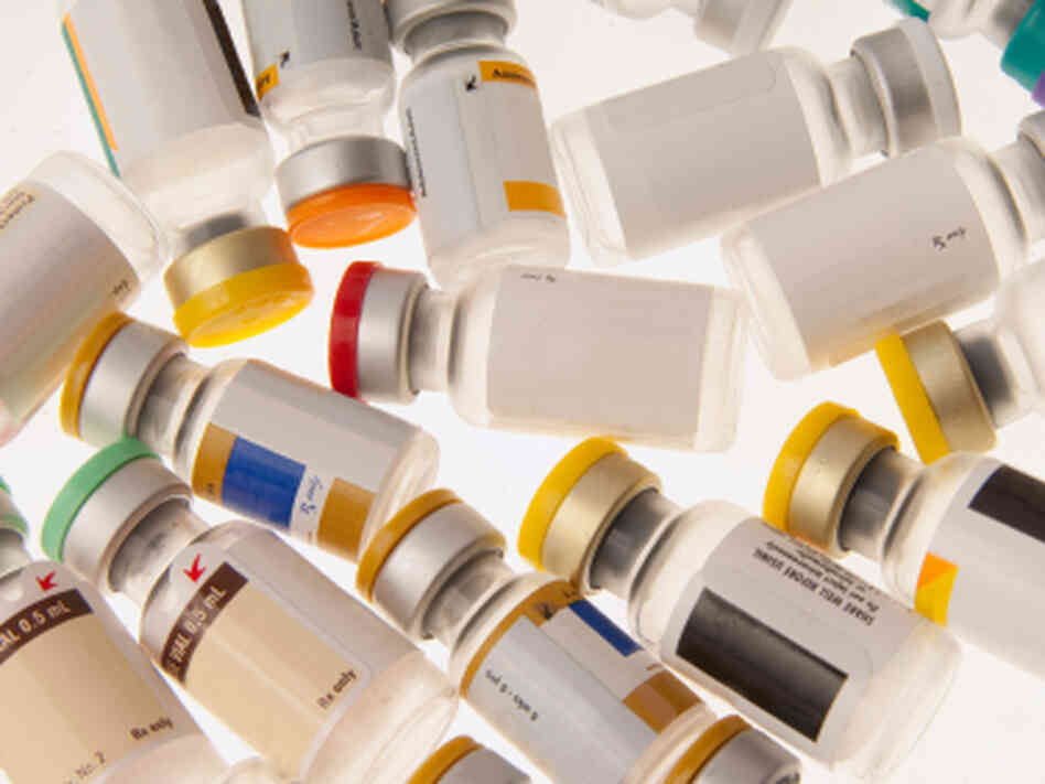 Vials of different vaccines with color-coded caps. Vials of different vaccines with color-coded caps.