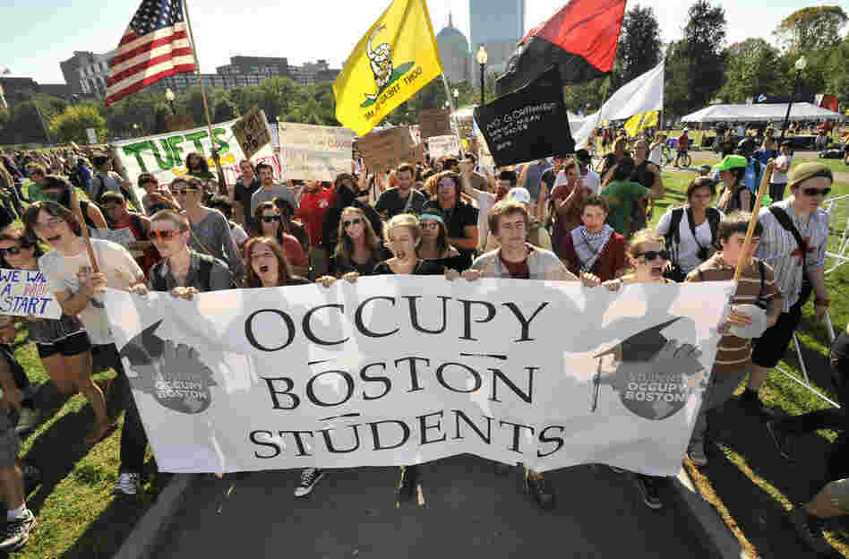 Demonstrators with Occupy Boston march through Boston Common on Monday afternoon. 