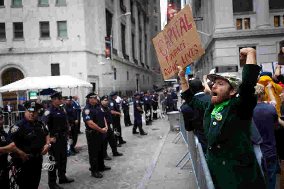 Protesters march on Wall Street amid heavy police presence on Sept. 20 in Manhattan. The demonstrators, who have been camping overnight in nearby Zuccotti Park since Sept. 17, were surrounded by police officers around the clock. 