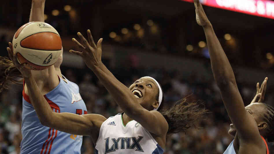 Minnesota Lynx guard Candice Wiggins (center) goes up for a shot against Atlanta Dream center Alison Bales (left) and forward Sancho Lyttle in the second half of Game 1 of the WNBA finals basketball series on Sunday. Minnesota Lynx guard Candice Wiggins (center) goes up for a shot against Atlanta Dream center Alison Bales (left) and forward Sancho Lyttle in the second half of Game 1 of the WNBA finals basketball series on Sunday.